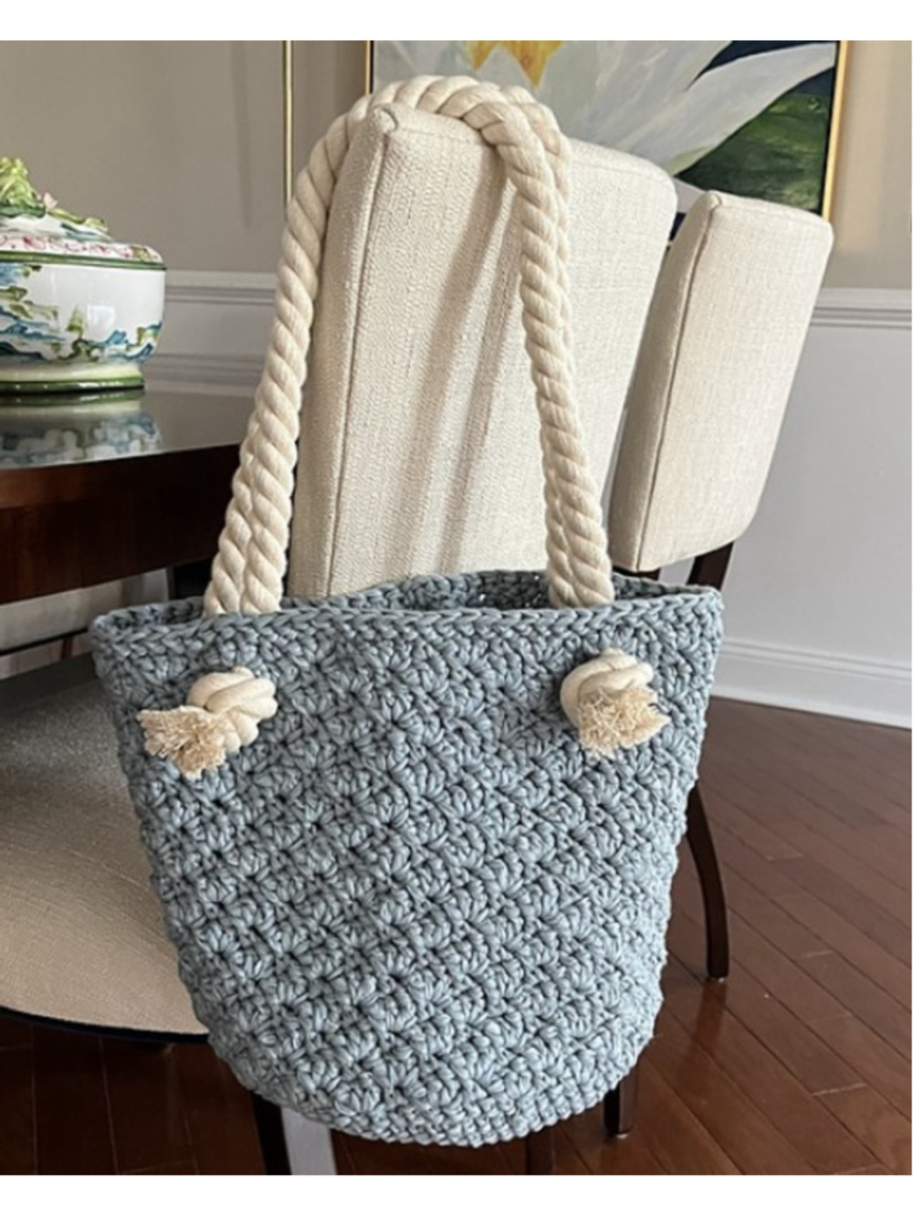 Textural artisan-crafted tote in soft blue-gray with cream rope handles.